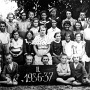 photo of graduating class from school in Venif, 1936-1937.<br />Note the lack of shoes.  Helen believes these were all Jewish students<br />pictured.  Second from left in back row (looking bald because of the<br />lighting) is Helen's only brother, Hersh Grossman.  Next to Hersh is<br />Helen's sister, Celie (also pictured in Page 109).  Celie and Hersh were<br />the 5th and 6th oldest children.  Third from the right in the back is<br />Gita Hoffman, a survivor living in Cleveland who provided this picture<br />through relatives in Florida that received it from her family before<br />the war.  Two girls down from Celie in the back row is Leah Kahn and<br />slightly below her and to her left is her sister, Tsuri Kahn.  In the<br />middle of the picture is the teacher.  To the teacher's left is Chaika<br />Kahn.  The three Kahn girls were first cousins of Helen.  Leah was<br />shot with her parents in an aktsia in the Borshov ghetto in 1943.<br />Tsuri stayed behind in Venif and then died just after liberation from<br />Auschwitz. Chaika was with Helen and her sister Ethel when they fled<br />to the woods in Borshov in Fall of 1943.  But Chaika went back to try<br />to find some shoes and was never heard from again.  Presumably she was<br />caught and killed then.
